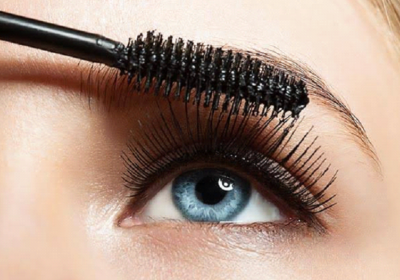 Woman applying waterproof mascara